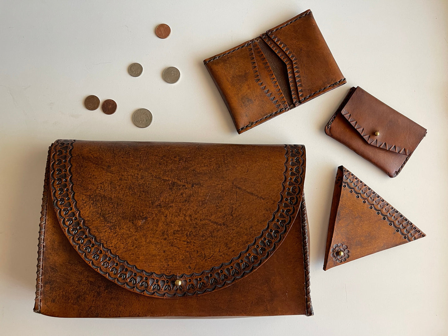 Set of brown leather wallets and coin pouches on a light background
